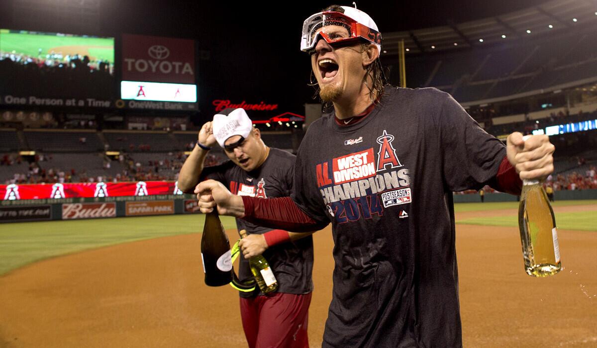 Angels pitcher Jered Weaver, right, and center fielder Mike Trout celebrate after the team won the AL West title on Wednesday night in Anaheim.
