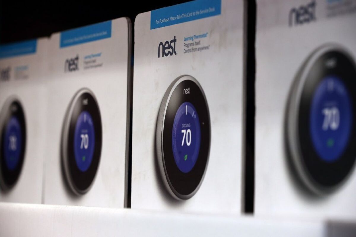 The Nest thermostat is displayed at a Home Depot store.