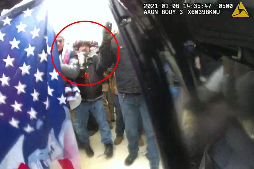 This image from police body-worn video, released and annotated by the Justice Department in the statement of facts supporting an arrest warrant for Markus Maly, shows Maly, circled in red, at the U.S. Capitol on Jan. 6, 2021, in Washington. (Justice Department via AP)