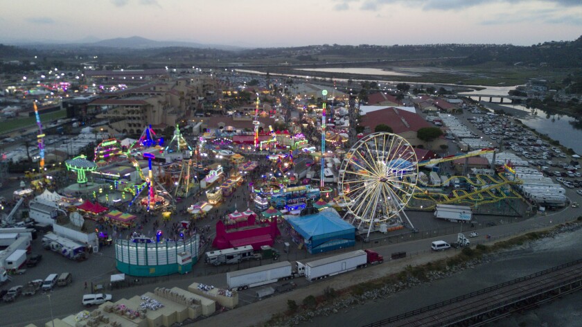 Lights of the Midway at the Del Mar fair are a rainbow of colors as the sun goes down..