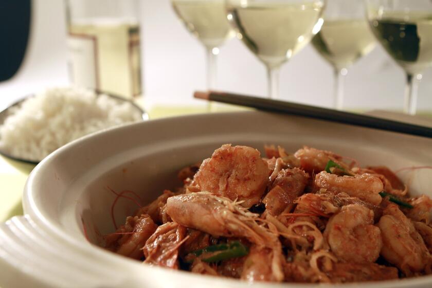 Caramelized lemongrass shrimp served with white rice and white wine.