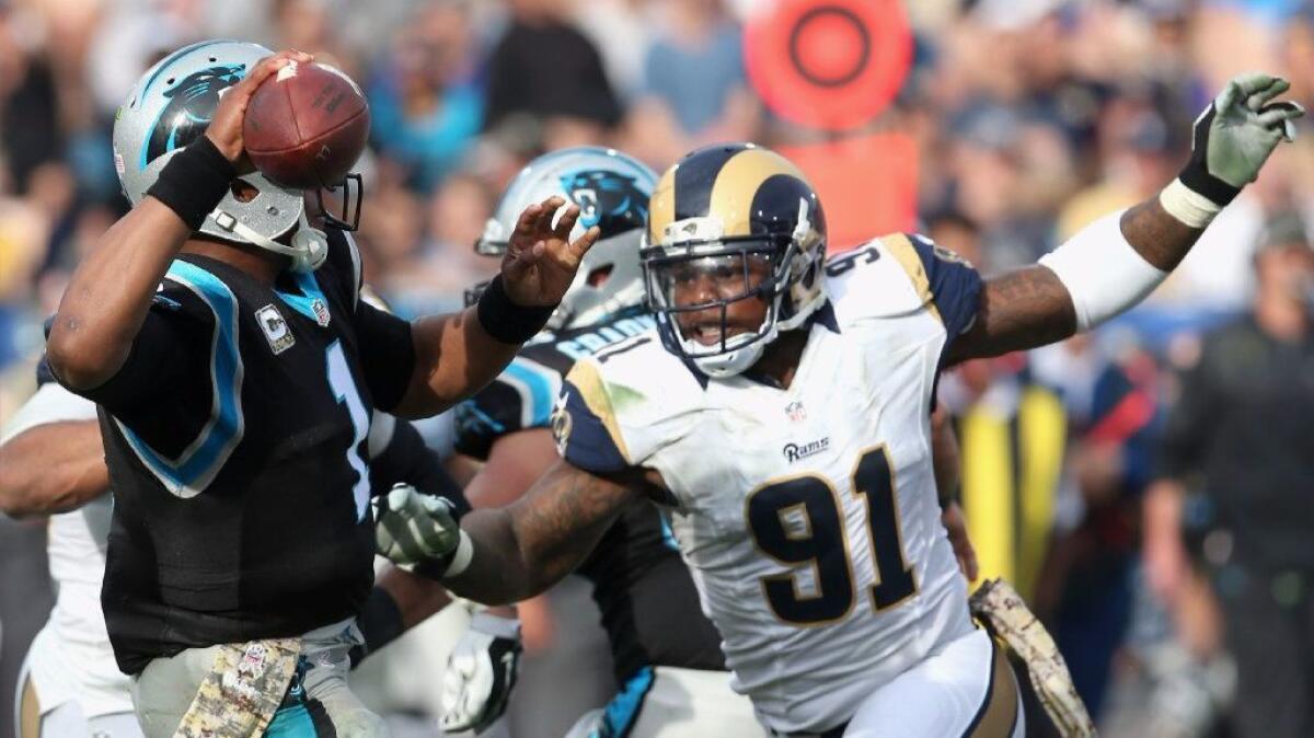 Rams defensive tackle Dominique Easley pressures Panthers quarterback Cam Newton during a Nov. 6 game.