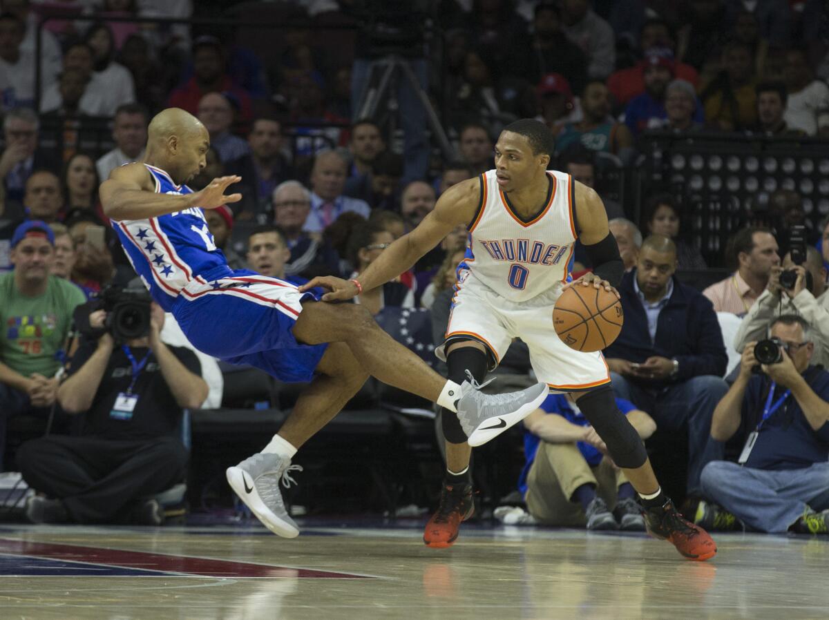 Thunder point guard Russell Westbrook (0) drives into 76ers defender Gerald Henderson (12) in the second quarter on Oct. 26.