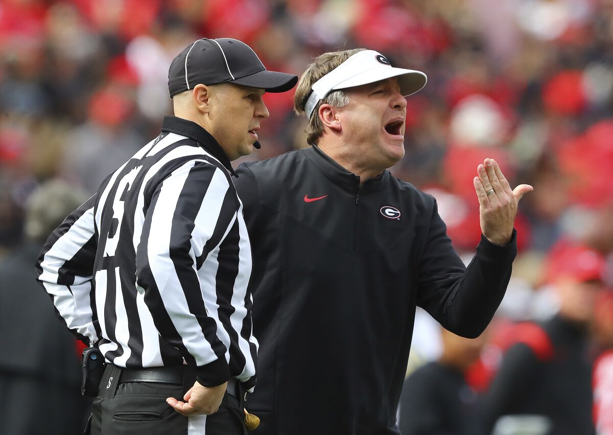 Georgia head coach Kirby Smart yells during the first half of an NCAA college football game against Missouri in Athens, Ga., Saturday, Nov. 6, 2021. The official at left is unidentified. (Curtis Compton/Atlanta Journal-Constitution via AP)