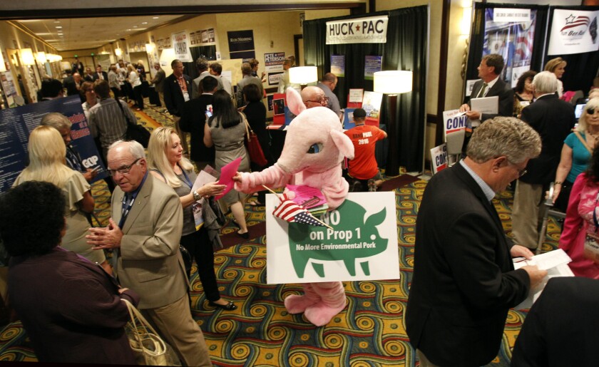 Delegates gather at the state Republican convention in Los Angeles. The pink pig was protesting government "pork."