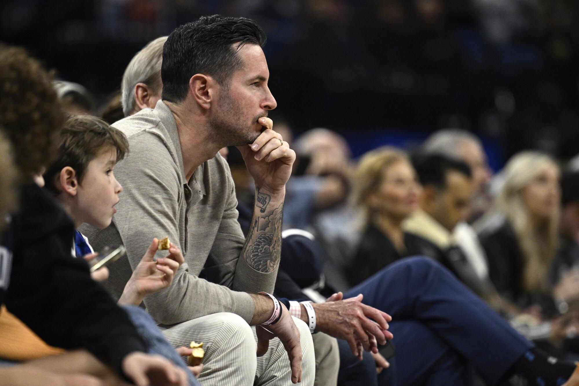 Former Magic guard JJ Redick watches a game in Orlando this past season.