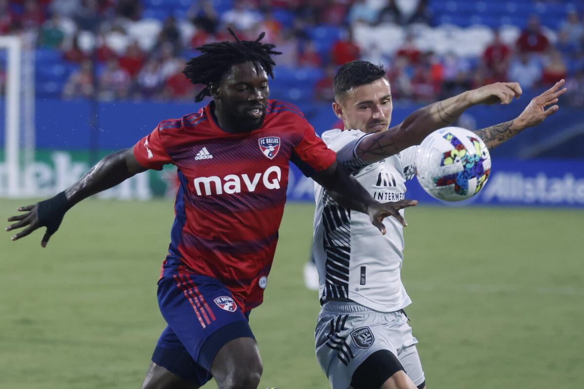 FC Dallas' Ema Twumasi, left, and San Jose Earthquakes' Paul Marie fight for the ball during the first half of an MLS match in Frisco, Texas, Saturday, Aug. 13, 2022. (Shafkat Anowar/The Dallas Morning News via AP)
