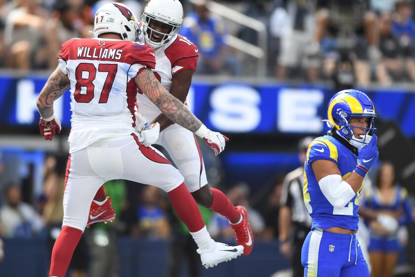 Inglewood, CA. October 3, 2021: Cardinals tight end Maxx Williams, left, celebrates his touchdown catch with A.J. Green as Rams safety Taylor Rapp walks away in the 2nd quarter at SoFi Stadium Sunday. (Wally Skalij/Los Angeles Times)