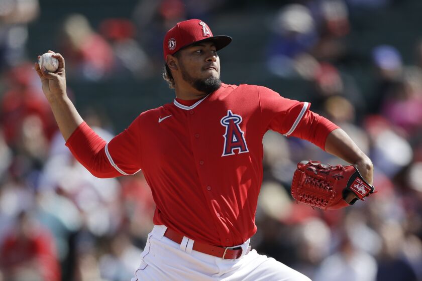 Los Angeles Angels starting pitcher Jaime Barria pitches to a Colorado Rockies batter during the first inning of a spring training baseball game Sunday, Feb. 23, 2020, in Tempe, Ariz. (AP Photo/Gregory Bull)
