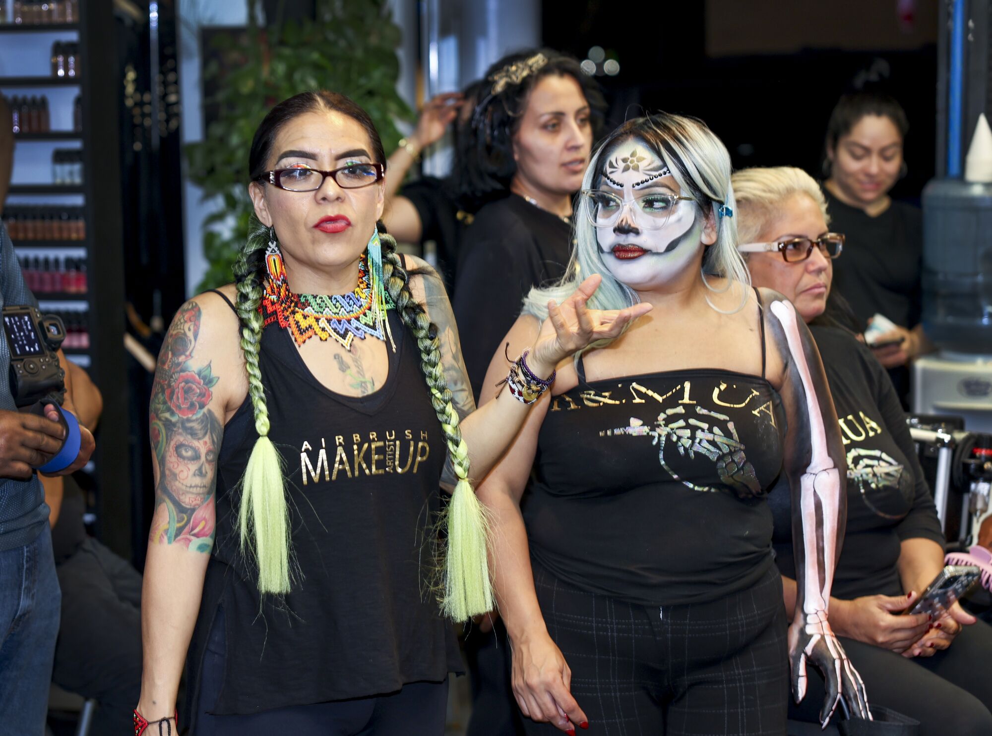 Livier Vera-Lopez, left, and Griselda Pelayo, watch a makeup class at a studio in Paramount.
