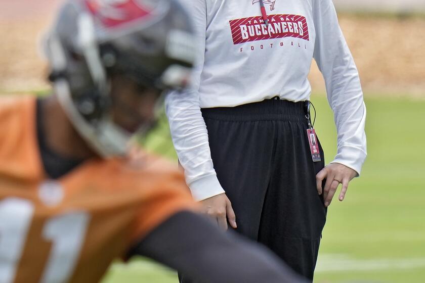 Ester Alencar, quarterbacks coach of the Rio Preto Weilers in Brazil, watches Tampa Bay Buccaneers quarterbacks at the NFL football team's rookie training camp, Friday, May 10, 2024, in Tampa, Fla. Twenty-five aspiring NFL coaches, with wide-ranging backgrounds, joined together at the inaugural Tampa Bay Buccaneers National Coaching Academy. (AP Photo/Chris O'Meara)