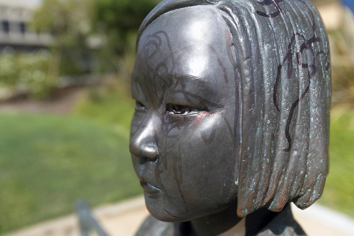 The Korean Comfort Women Peace Monument in Glendale’s Central Park on Monday after it was vandalized by an unknown person who used a black permanent marker to scrawl all over the statute.