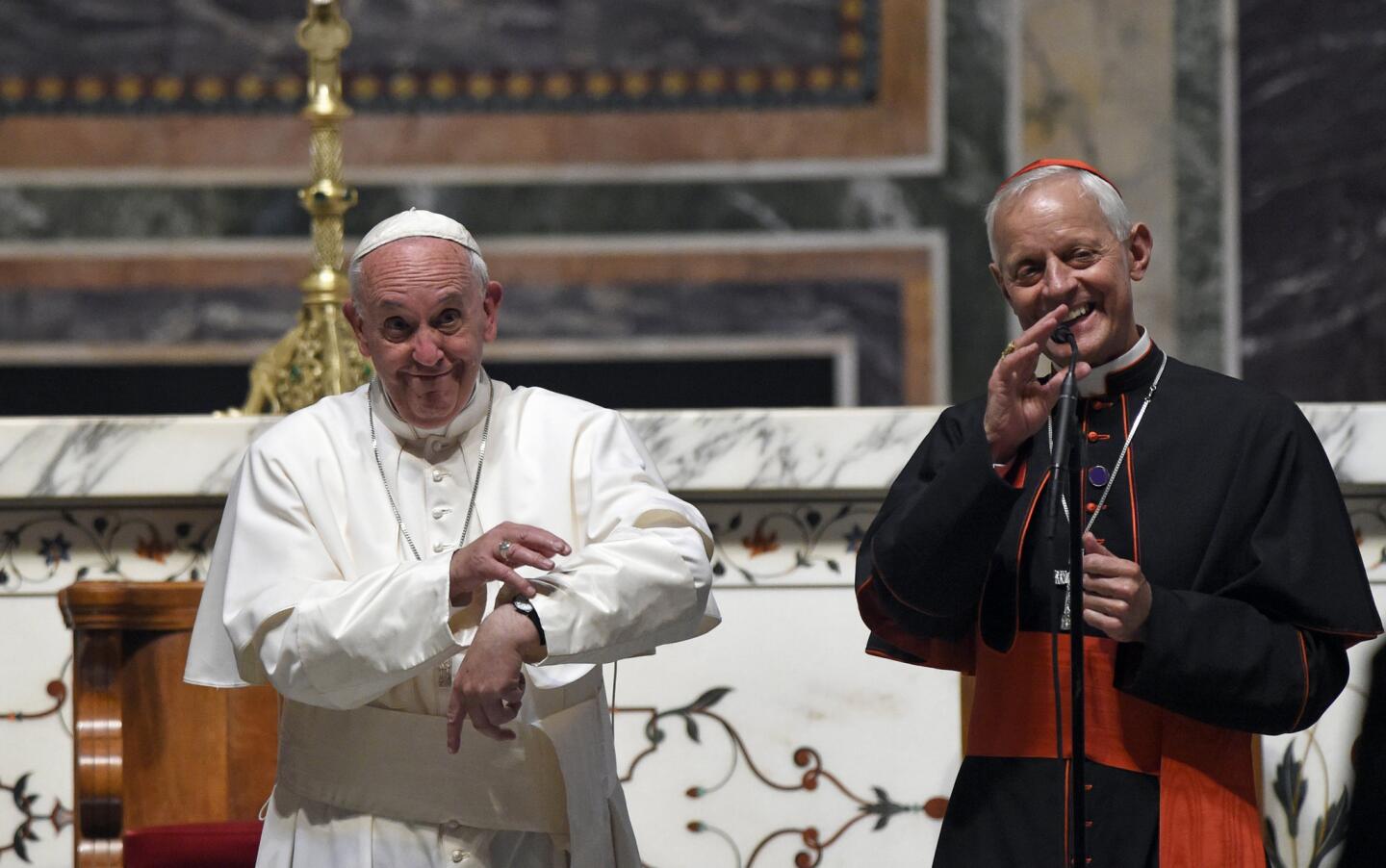 Cardinal Donald Wuerl, archbishop of Washington, right, translates for Pope Francis as the pontiff laments that he won't have time to greet everyone after a midday prayer with U.S. bishops on Sept. 23, 2015, at St. Matthew's Cathedral in Washington.