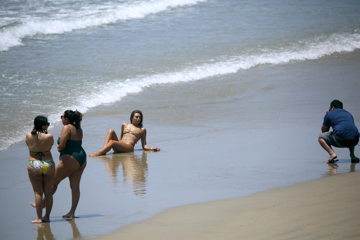 A model has her photos taken near the Newport Pier on Saturday.