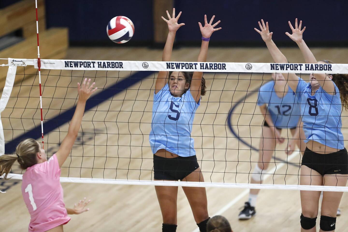 South's Ashley Humphreys (Corona del Mar) hits into North's Jillian Kim (Huntington Beach), center, and Brooke Beresford (Esperanza) during the 41st Dave Mohs Memorial Orange County High School Volleyball All-Star girls' match on Friday, June 1.