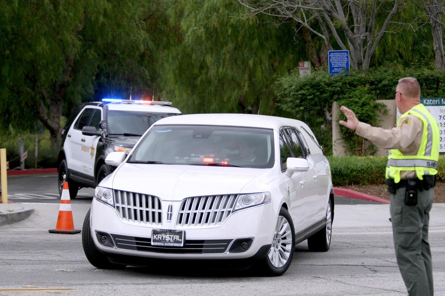 A hearse is escorted out after memorial service for Cecilia Hoschet at St. Kateri Tekakwitha Catholic Church in the city of Santa Clarita on Wednesday, Sept. 16, 2015. Hoschet was allegedly killed by her husband at their La Cañada Flintridge home recently and then he committed suicide.