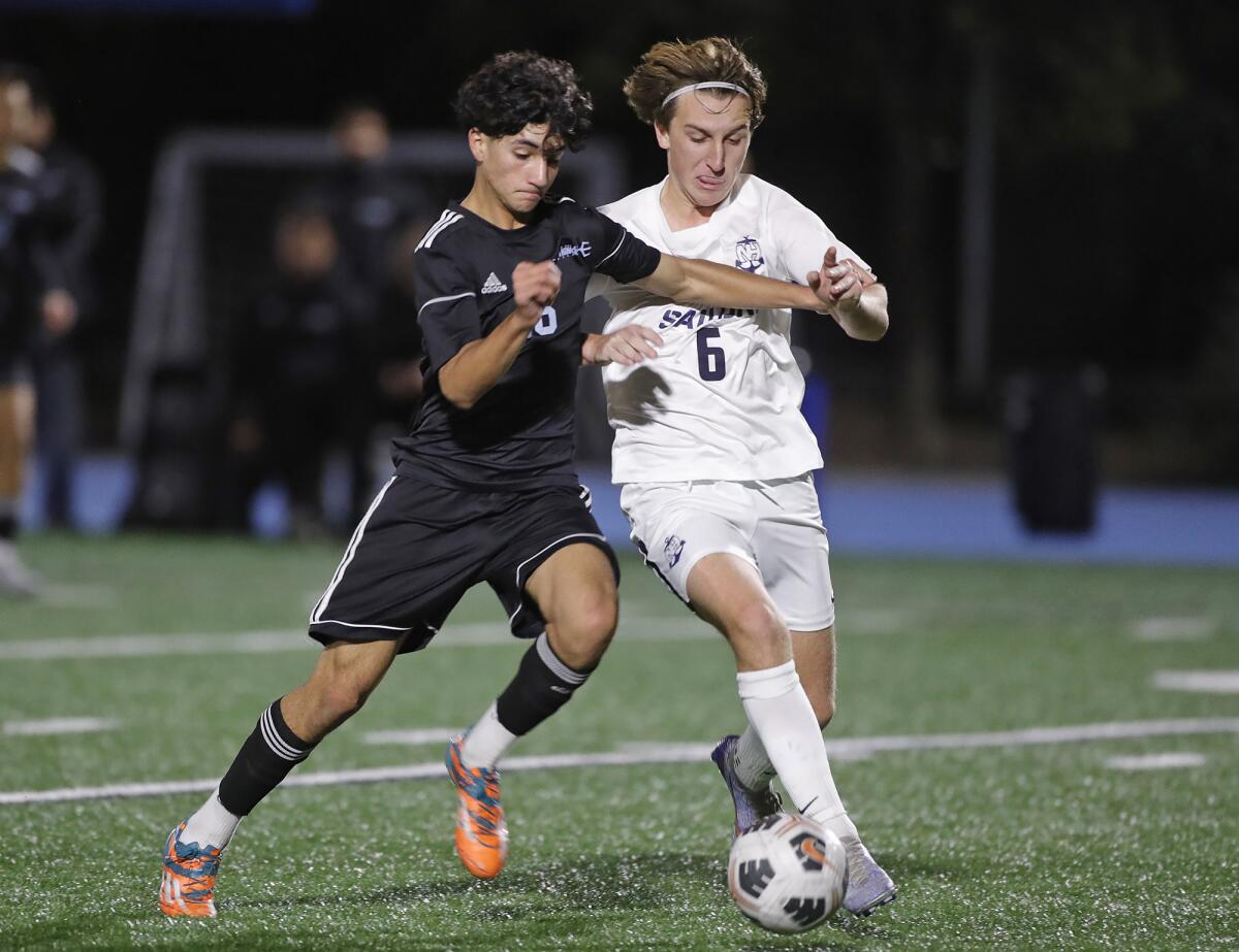 Newport Harbor's James Evans, right, scored for the Sailors against Los Alamitos on Saturday.