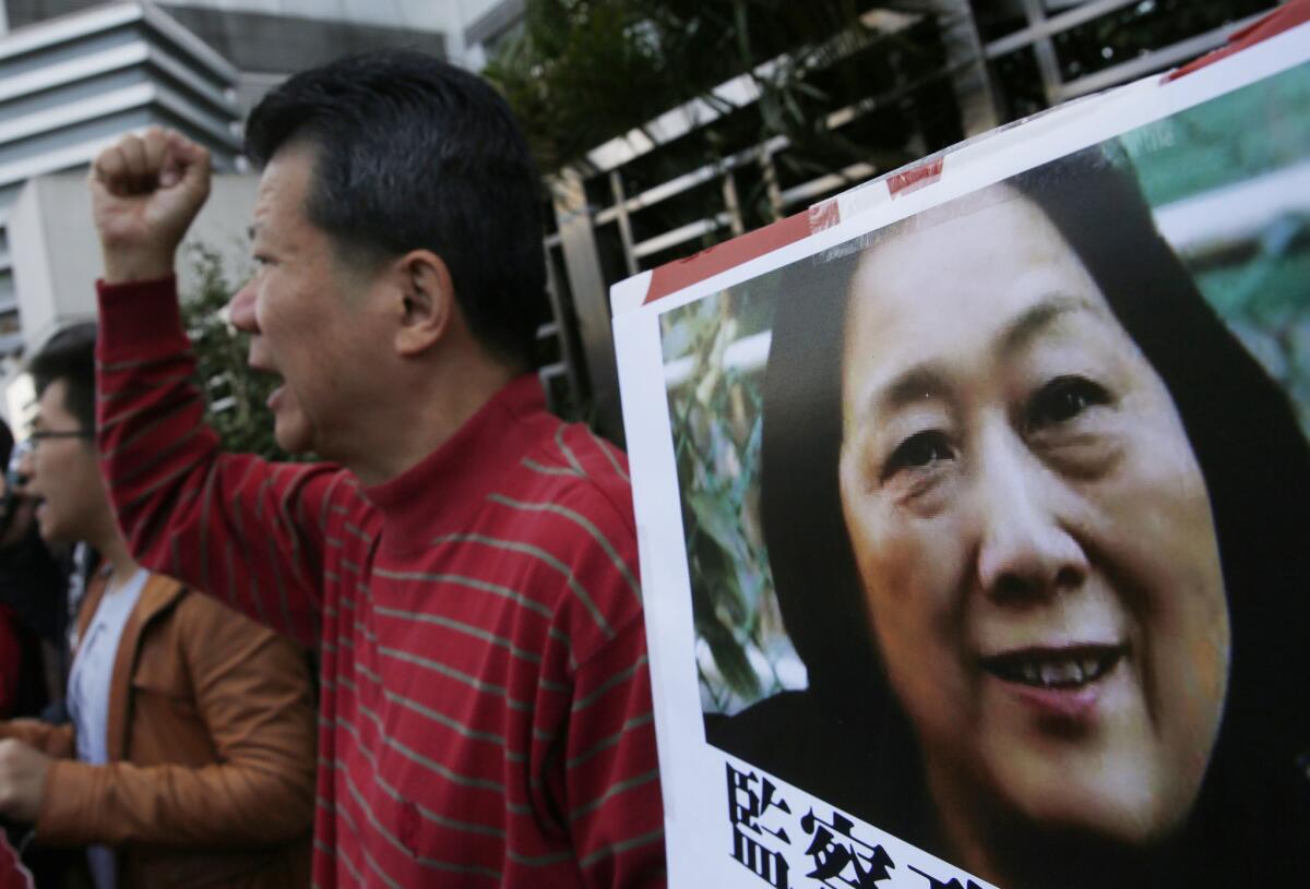 Anti-Beijing protesters hold a picture of Chinese journalist Gao Yu at a rally outside the Chinese central government's liaison office in Hong Kong.