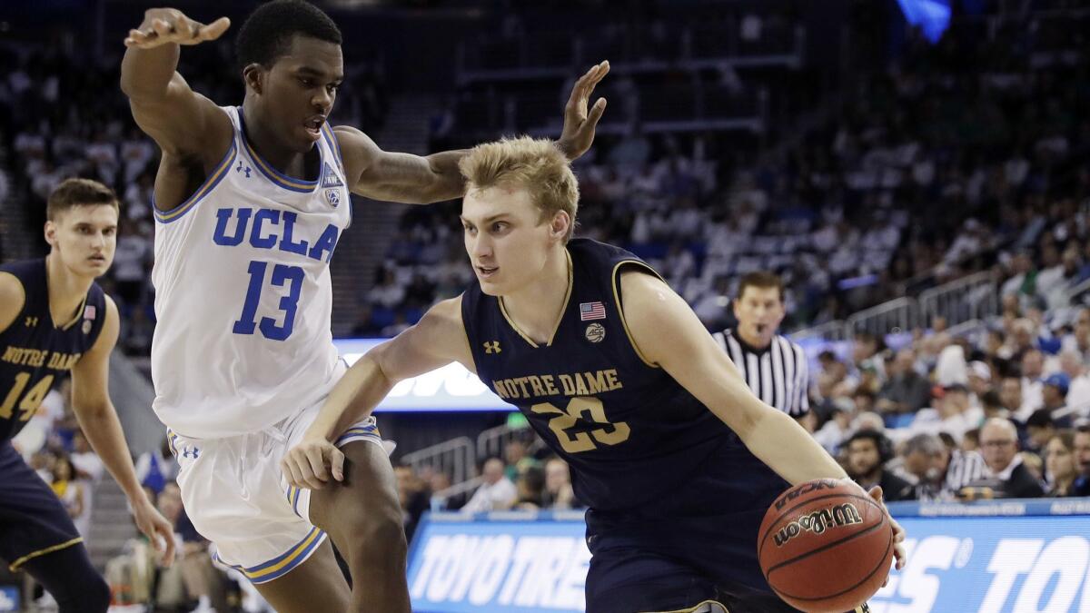 Notre Dame guard Dane Goodwin (23) dribbles past UCLA guard Kris Wilkes (13) during the first half on Saturday.