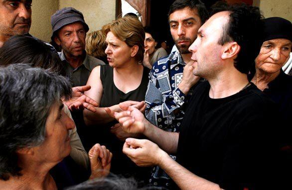 A group of displaced people question a government official, right, about finding supplies and housing in Tbilisi. The Georgian government had few answers. The relief effort by the Georgian government to aid those fleeing their villages and towns is in disarray. Outside the Ministry of Refugees and Settlements the scene was chaotic as hundreds of frustrated people expressed their fury at officials. Many were complaining of a total lack of food, water, shelter and assistance.