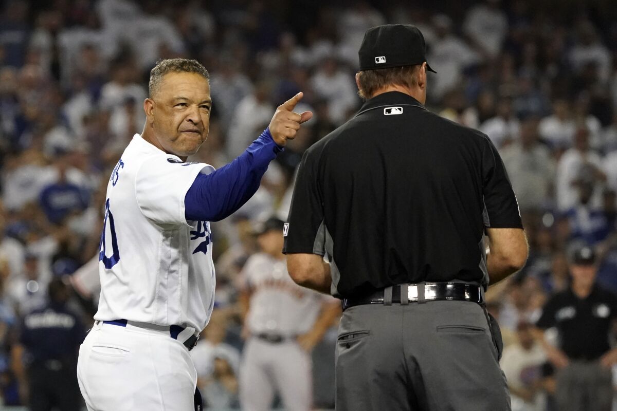 Dodgers manager Dave Roberts argues with first base umpire Ed Hickox in the ninth inning Thursday.