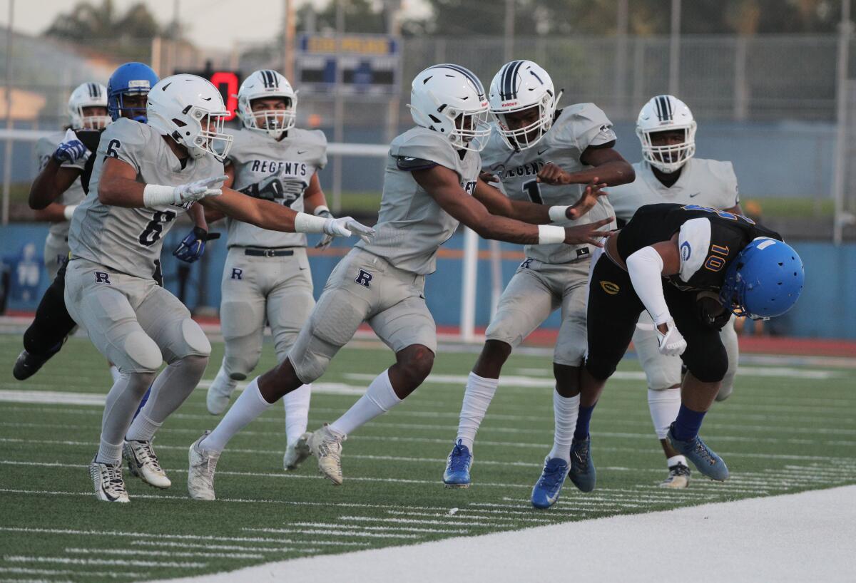 Five Reseda defenders team up to force Crenshaw wide receiver Centrell Wise out of bounds.