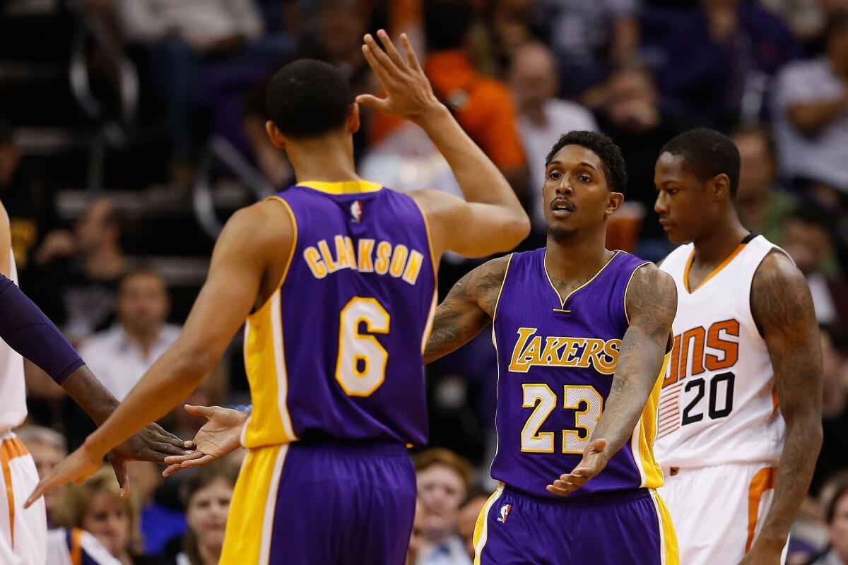 PHOENIX, AZ - NOVEMBER 16: Louis Williams #23 of the Los Angeles Lakers high fives Jordan Clarkson #6 after scoring against the Phoenix Suns during the NBA game at Talking Stick Resort Arena on November 16, 2015 in Phoenix, Arizona. The Suns defeated the Lakers 120-101. NOTE TO USER: User expressly acknowledges and agrees that, by downloading and or using this photograph, User is consenting to the terms and conditions of the Getty Images License Agreement. (Photo by Christian Petersen/Getty Images) ** OUTS - ELSENT, FPG, CM - OUTS * NM, PH, VA if sourced by CT, LA or MoD **