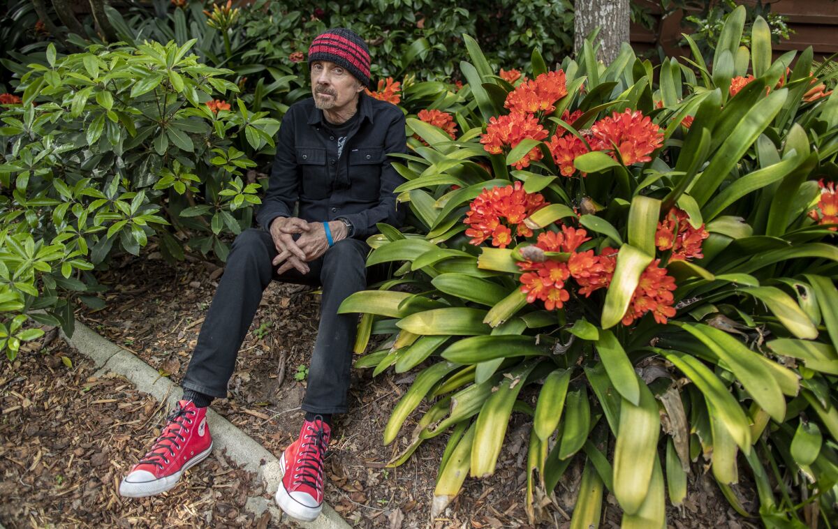 Novelist T. C. Boyle in the garden among blooming Clivia outside his Frank Lloyd Wright-designed home in Montecito, Calif., on March 26, 2019.
