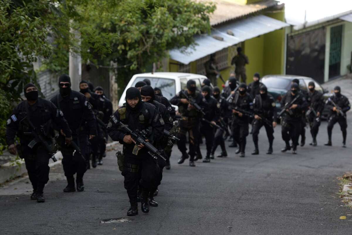 Members of the Salvadorean National Civil Police participate in an operation in search of gang members in San Salvador on May 12.