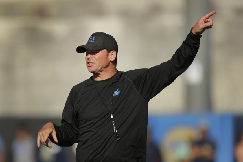 UCLA Coach Jim Mora gestures during a practice on campus Apr. 20.