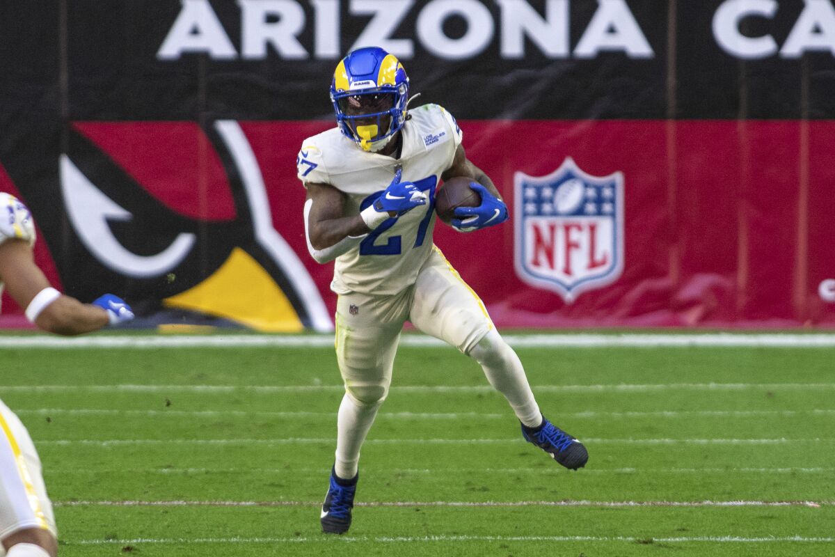 Rams running back Darrell Henderson (27) carries the football against  the Arizona Cardinals in December.