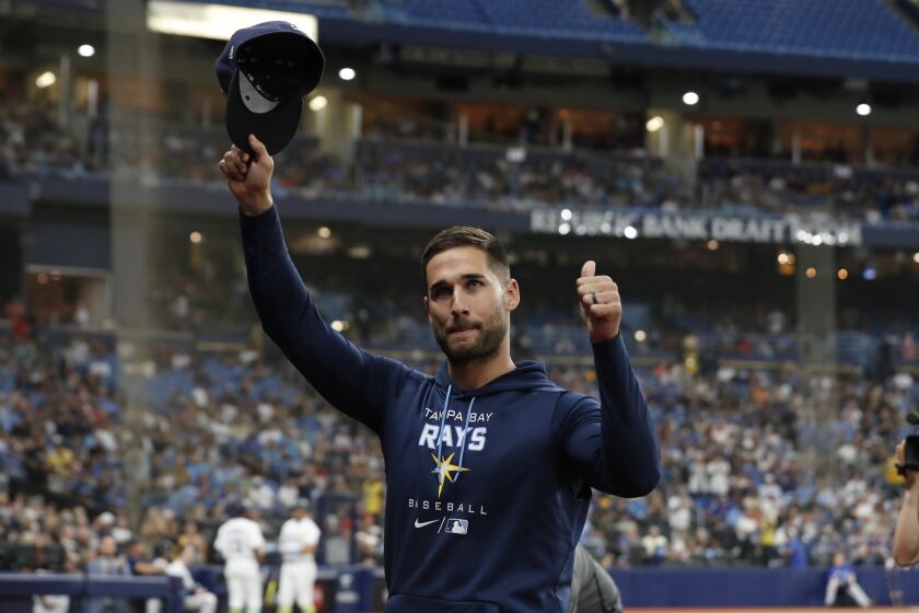 Tampa Bay Rays' Kevin Kiermaier gestures to fans after a video tribute to him, during the second inning of the team's baseball game against the Toronto Blue Jays on Saturday, Sept. 24, 2022, in St. Petersburg, Fla. Kiermaier is out for the season. (AP Photo/Scott Audette)