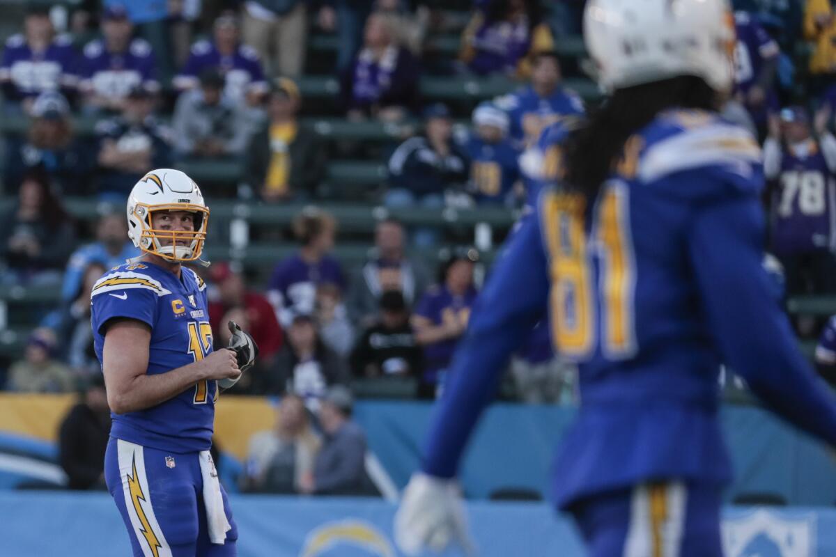 Chargers quarterback Philip Rivers walks off the field after throwing his third interception against the Vikings on Sunday.