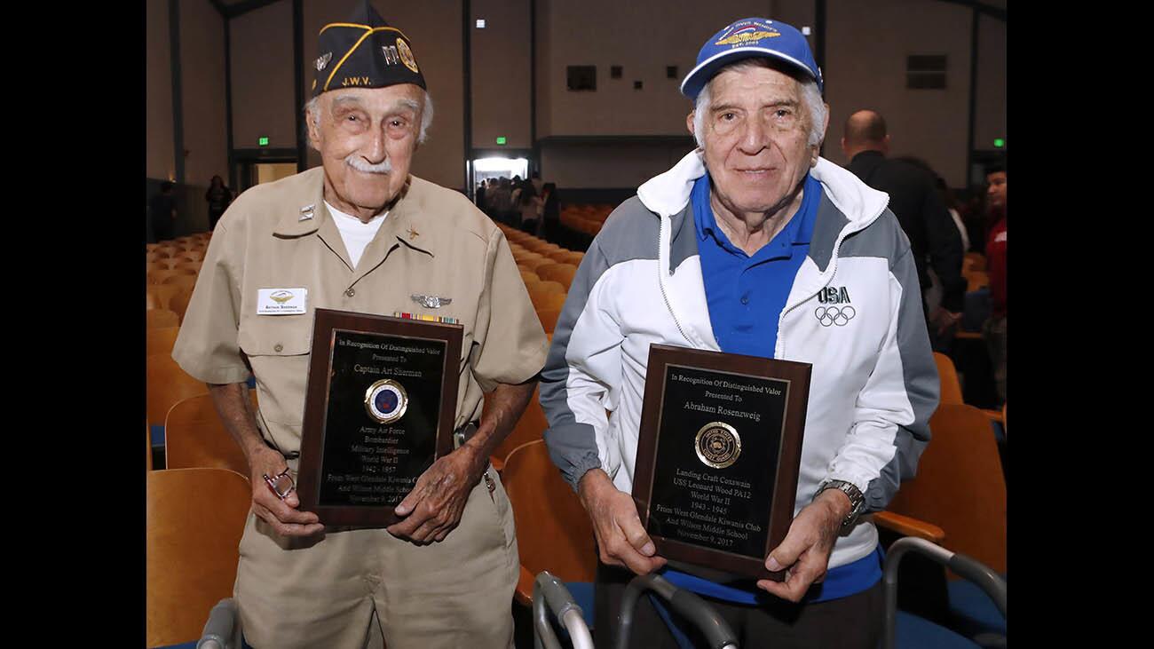 World War II veterans Army Air Force bombardier Capt. Art Sherman, left, and U.S. Coast Guard Abraham Rosenzweig, right, received plaques in recognition of distinguished valor during the annual Wilson Middle School Veteran's Day Assembly at the school in Glendale on Thursday, Nov. 9, 2017.