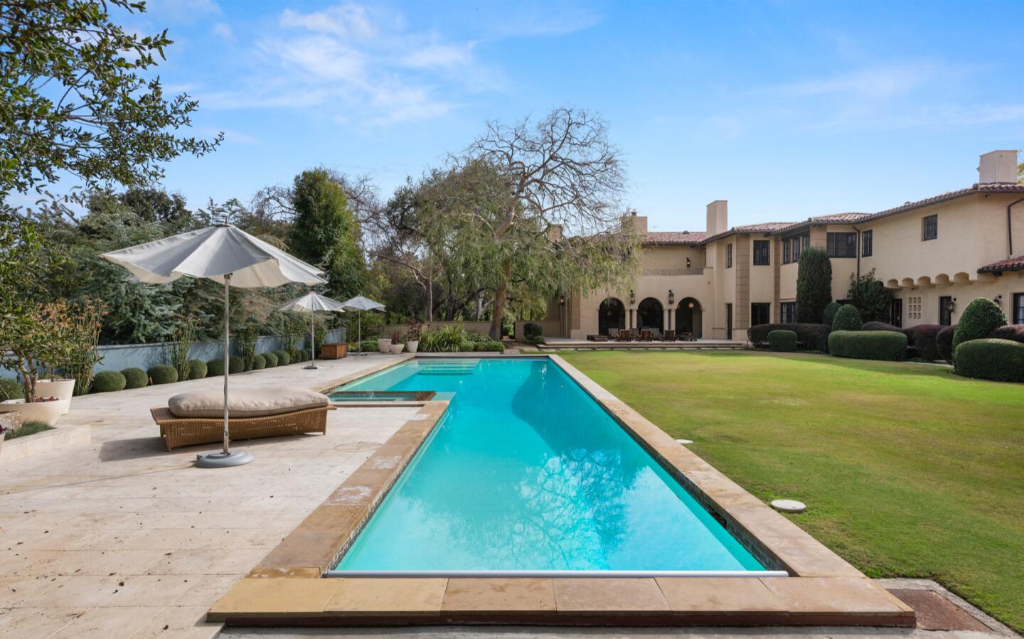 A long, rectangular pool at the rear of the house.