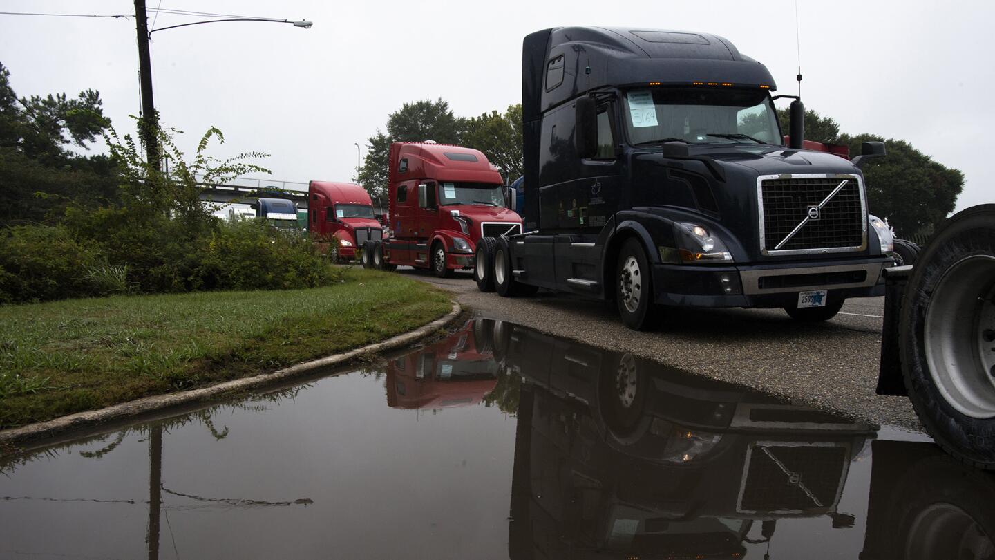 Trucks line up outside Maxwell Air Force base to prepare to load Federal Emergency Management Agency trailers waiting on base to take to Hurricane Irma affected areas on Tuesday, Sept. 12, 2017, in Montgomery, Ala.
