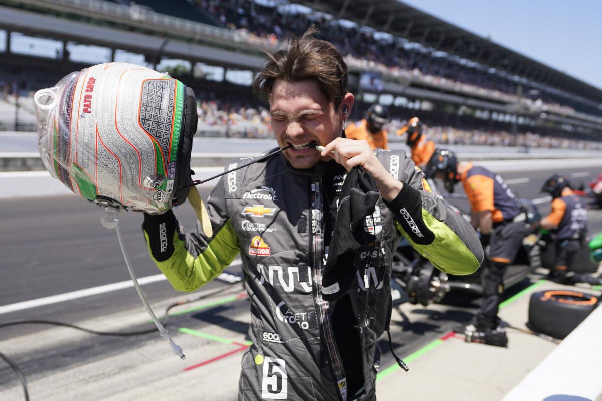 Pato O'Ward, of Mexico, takes off his helmet following the final practice for the Indianapolis 500.
