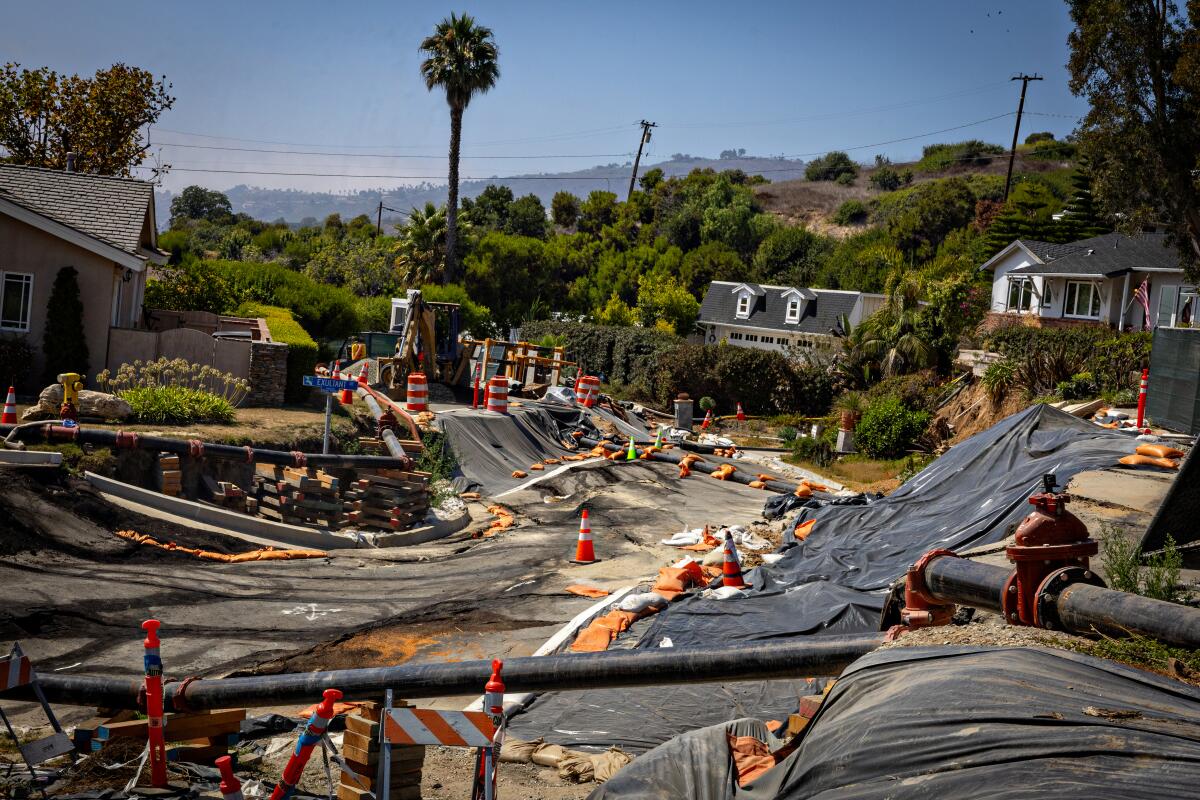 Cones and tarp cover landslide damage.