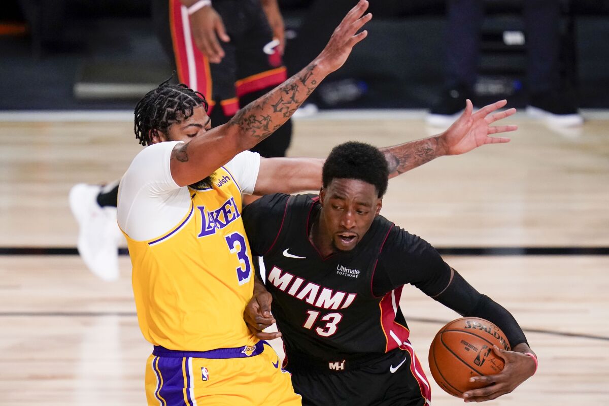 Heat forward Bam Adebayo picks up a foul by charging into Lakers forward Anthony Davis during the Game 4.