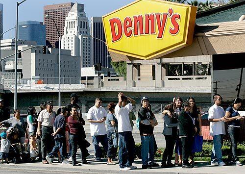 A line forms outside a downtown Los Angeles Denny's.
