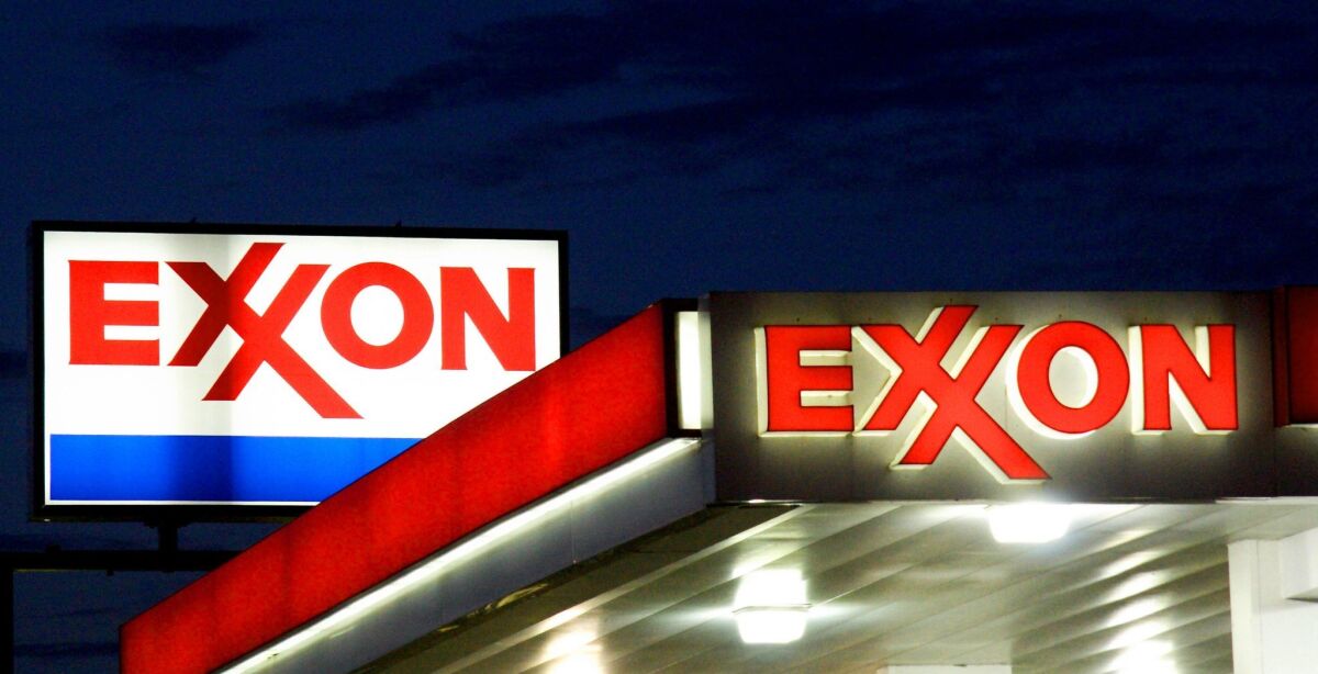 An Exxon sign is seen at a gas station in Manassas, Va.