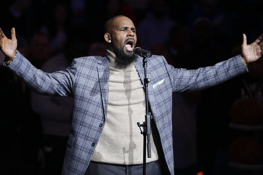 FILE - In this Nov. 17, 2015, file photo, musical artist R. Kelly performs the national anthem before an NBA basketball game between the Brooklyn Nets and the Atlanta Hawks in New York. As critics of the singer seek to cancel his shows because of his alleged mistreatment of women, a community leader in North Carolina says she and others will stage a protest if his Friday show in Greensboro takes place. (AP Photo/Frank Franklin II, File)
