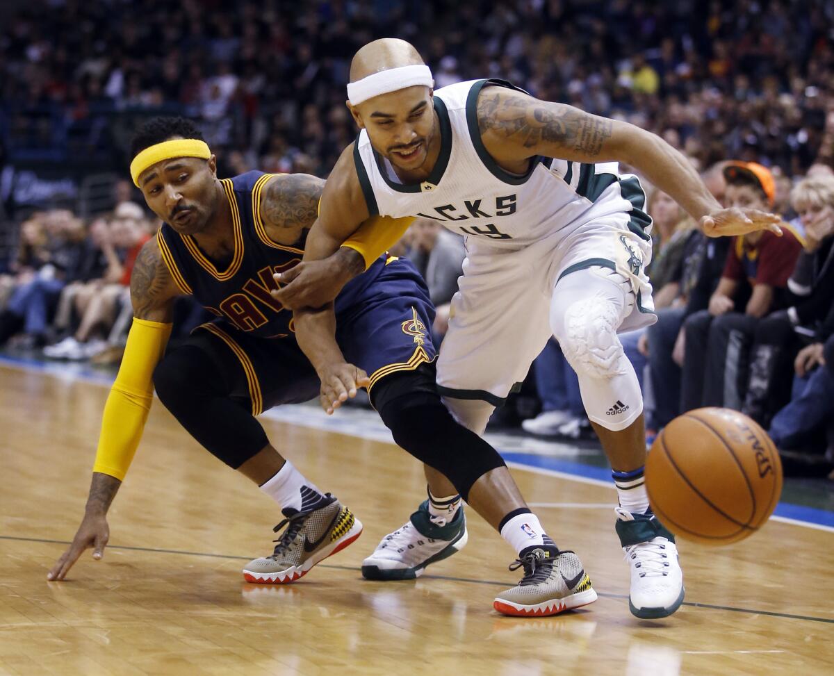 Cleveland's Mo Williams and Milwaukee's Jerryd Bayless go after a loose ball.