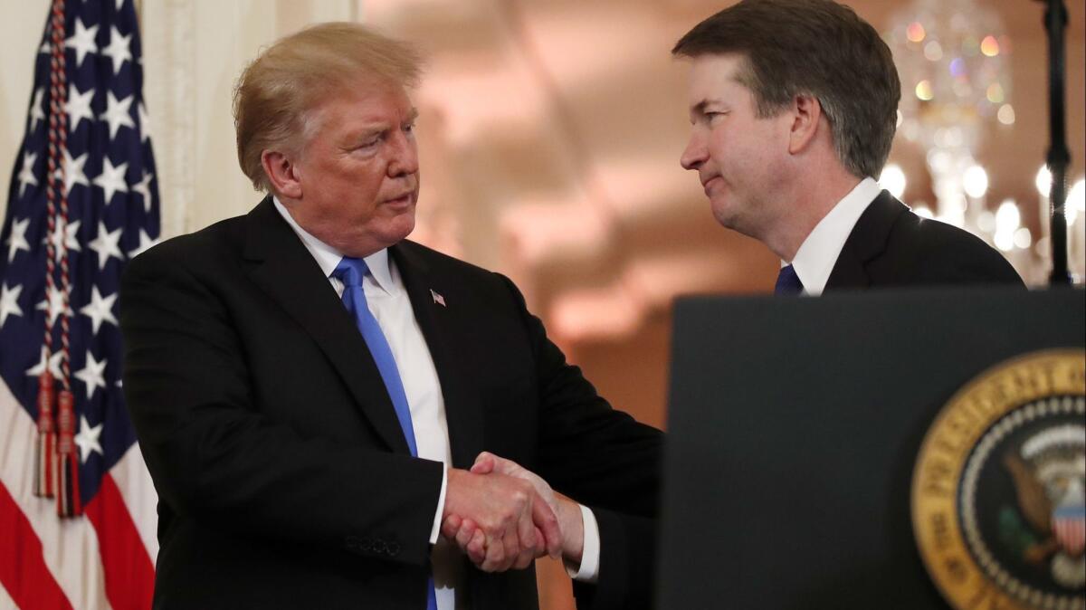President Donald Trump shakes hands with Judge Brett Kavanaugh his Supreme Court nominee, in the East Room of the White House on July 9.