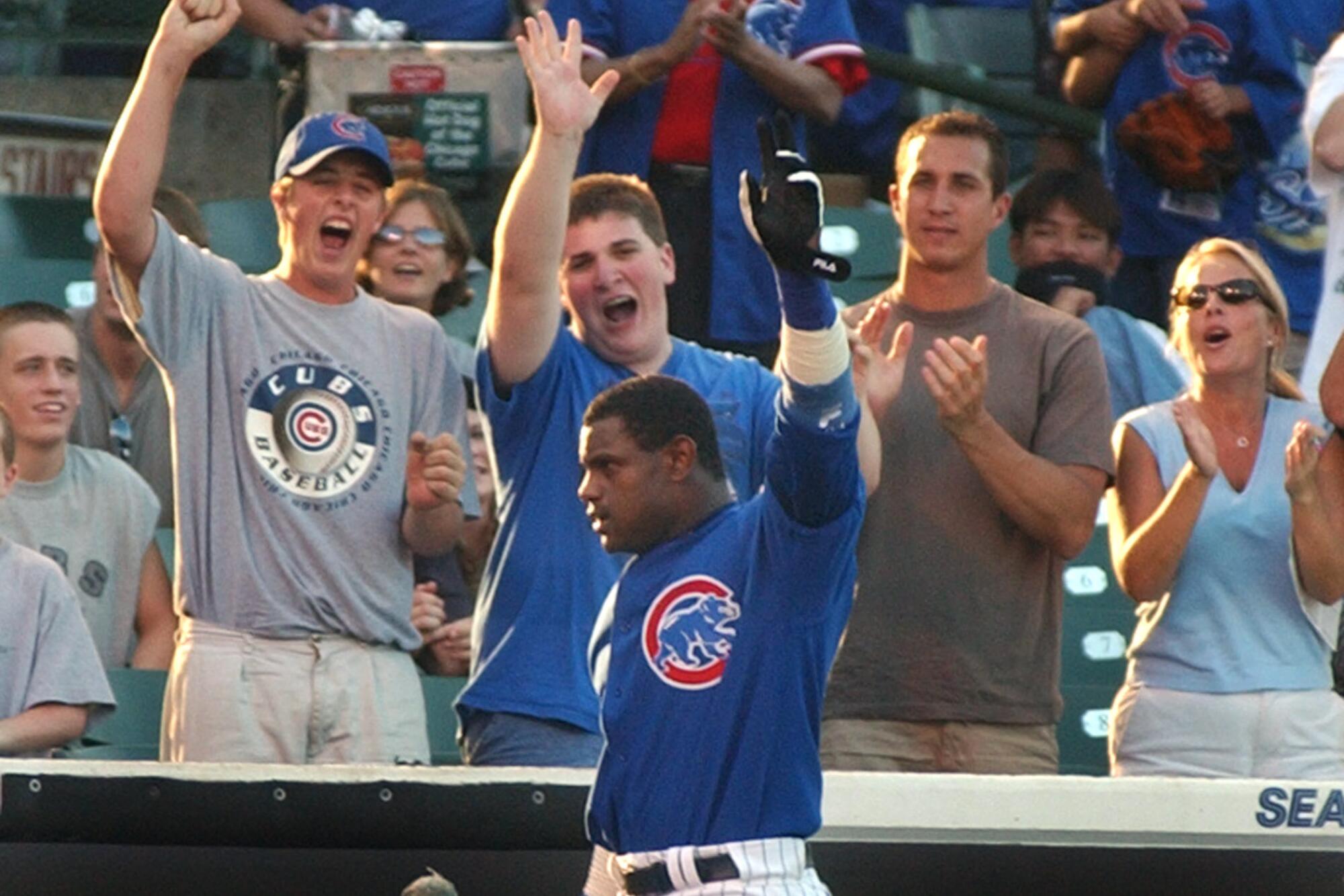 Chicago Cubs' Sammy Sosa, center front, waves to fans after hitting a home run in 2002.