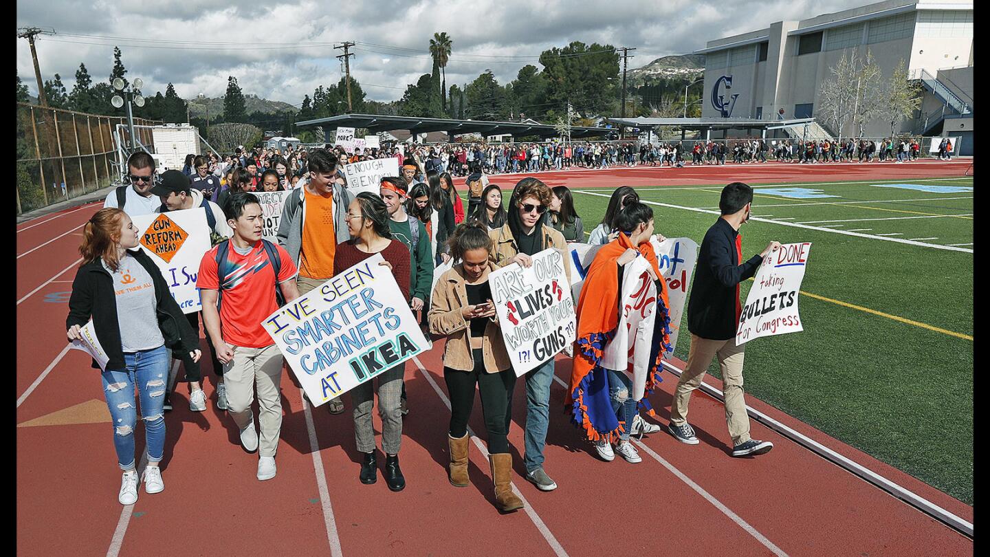 Students take a short lap around the track at a student organized and lead protest in solidarity with students nationwide at Crescenta Valley High School on Wednesday, March 14, 2018. Nearly all Crescenta Valley students participated by taking a lap around half of the track, and the seventeen students killed at Marjory Stoneman Douglas High School were recognized individually as their names were spoken with the release of a white dove. The focus of the student protest was for gun control.