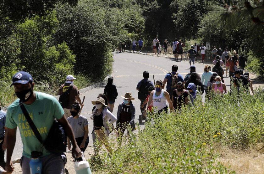 Visitors stream in and out of Eaton Canyon Natural Area park on Sunday in Pasadena during the Memorial Day weekend, before the Los Angeles County Parks and Recreation Department closed the trails.