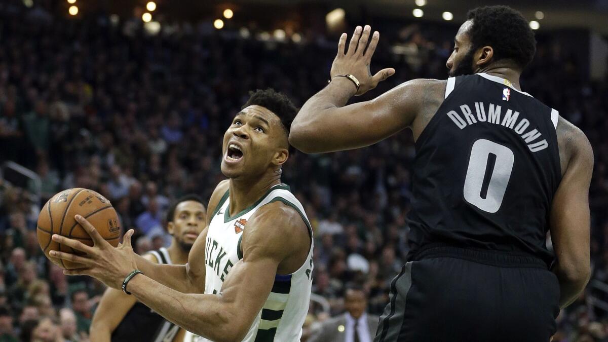 Milwaukee Bucks' Giannis Antetokounmpo drives to the basket against Detroit Pistons' Andre Drummond.