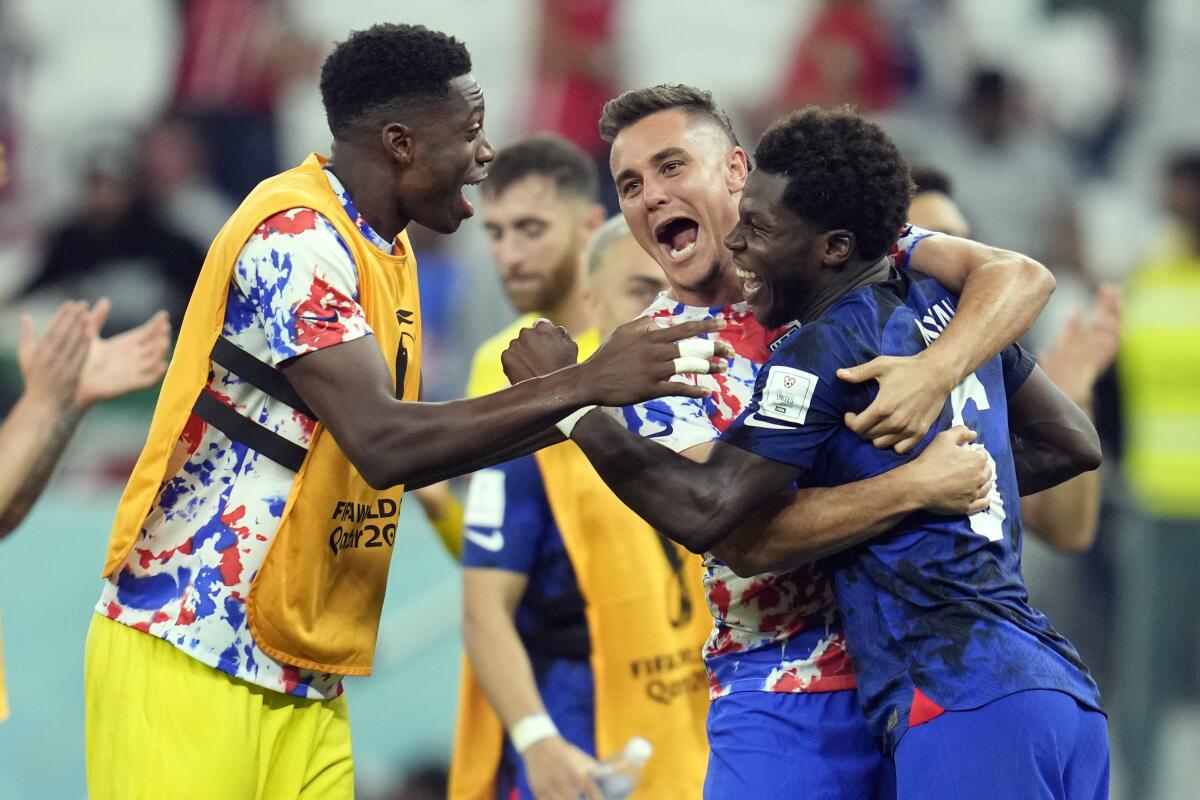 U.S. players (from left) Sean Johnson, Aaron Long and Yunus Musah celebrate after defeating Iran on Tuesday.