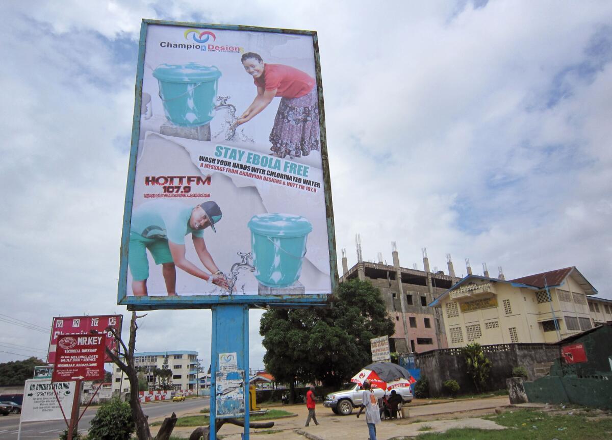 A billboard promotes hand washing to help prevent the spread of Ebola in Monrovia, Liberia. A suspected outbreak in Congo has killed 13 people but the government says it is a different strain of the virus than the one spreading through four West African countries.